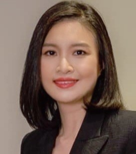 A person with dark hair wearing a black suit

Description automatically generated